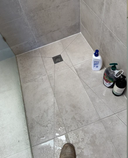 Shower base regrout before and after photos